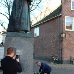 Laying flowers at Comenius' statue